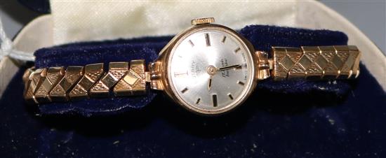 A ladys 9ct gold Rotary watch, on a gold plated flexible bracelet.
